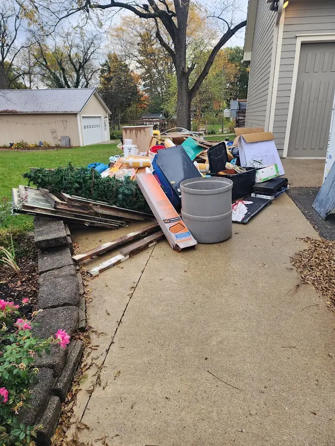 Dumpster being loaded with debris for Residential Dumpster Rental in Nacogdoches